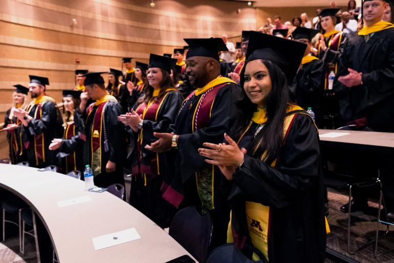 Master of Science in Supply Chain Mangement class of 2023 graduates clapping after speech.
