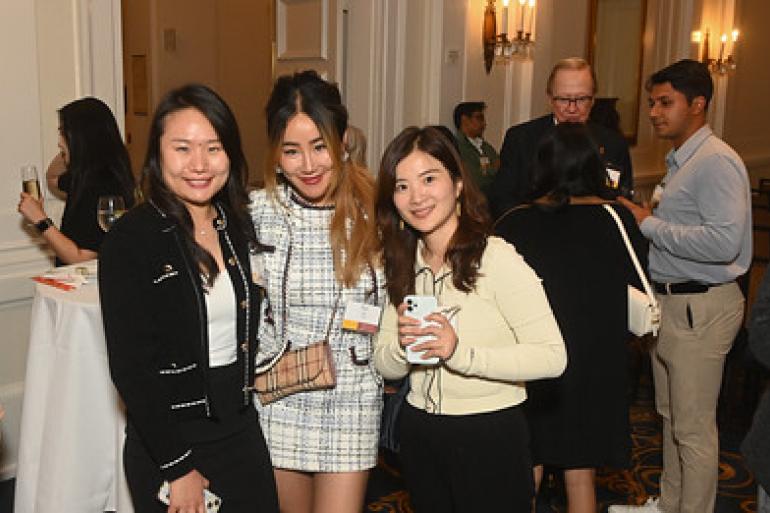 Three alumni posed and smiling at the Regional San Francisco Event